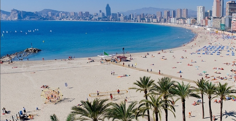 Playa de Poniente curving toward the skyline