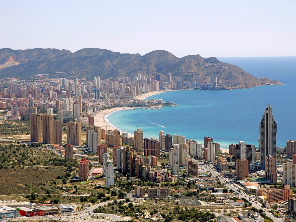 Aerial view over Benidorm: Poniente bay, the skyline and Sierra Helada behind